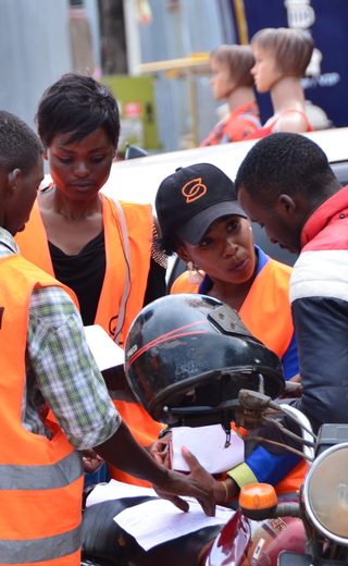 Field activation team briefing riders in Kampala