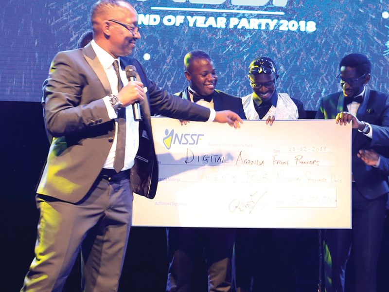 Cheque presentation on stage at an event produced by Kijoh